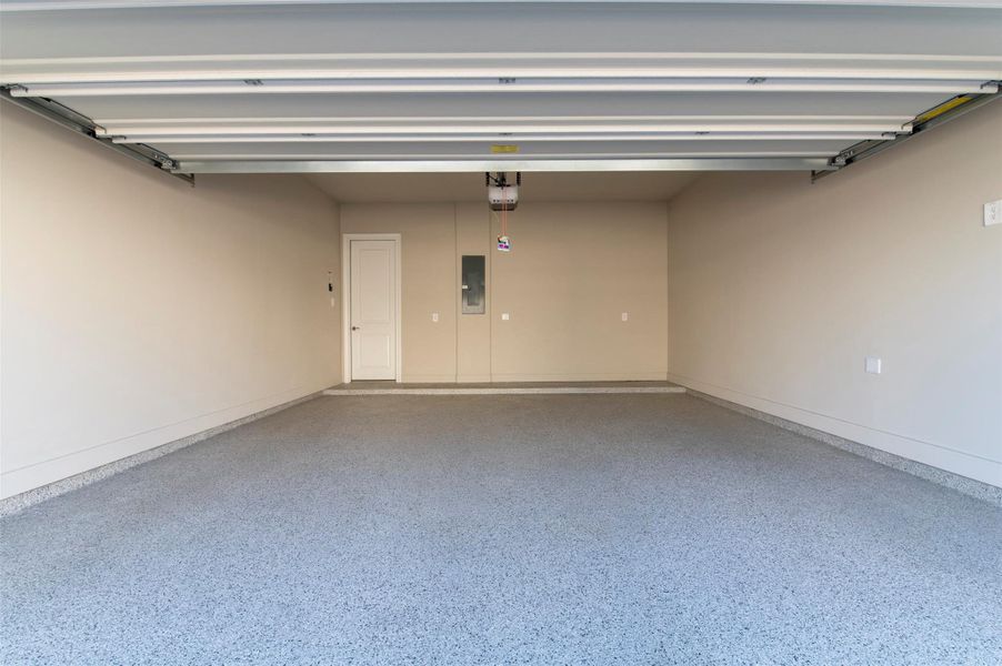Spacious two-car garage with overhead storage potential and clean finishes.