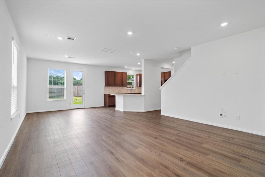 Spacious open-concept design seamlessly connecting the living, dining, and kitchen areas—perfect for both everyday living and entertaining!