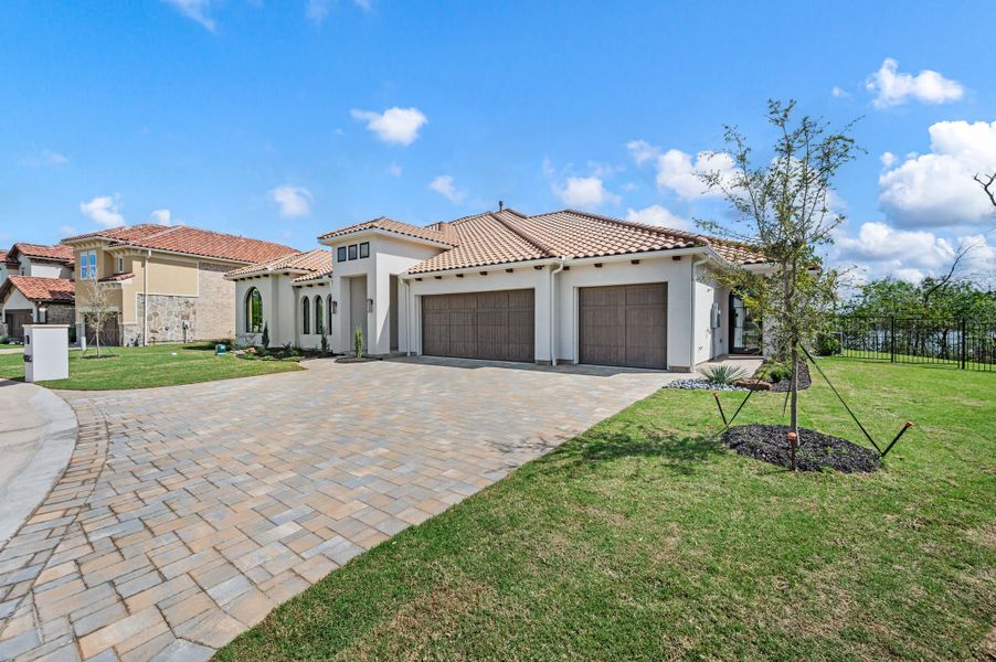 Front exterior of a new home in The Resort on Eagle Mt. Lake, Fort Worth, TX, highlighting curb appeal (Image 2). Front exterior of a new home in The Resort on Eagle Mt. Lake, Fort Worth, TX, highlighting curb appeal (Image 2).