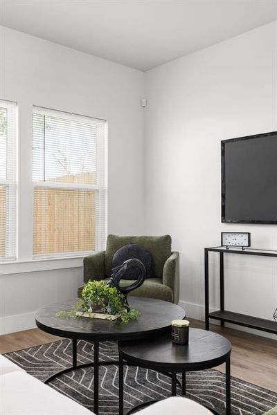 Living area with baseboards and wood finished floors