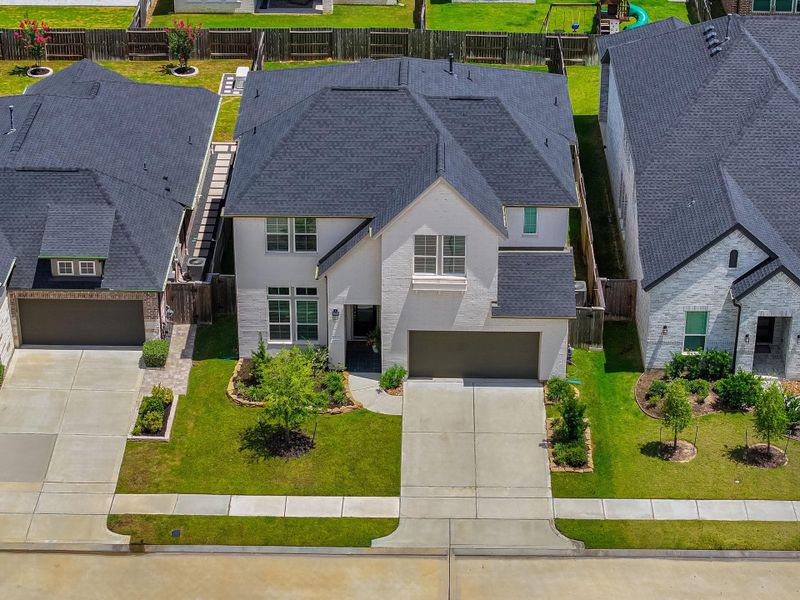 Front exterior of a new home in Lakes at Creekside 50′, Tomball, TX, highlighting curb appeal (Image 23). Front exterior of a new home in Lakes at Creekside 50′, Tomball, TX, highlighting curb appeal (Image 23).