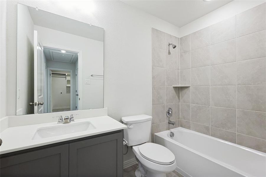 Bathroom featuring vanity and shower / washtub combination