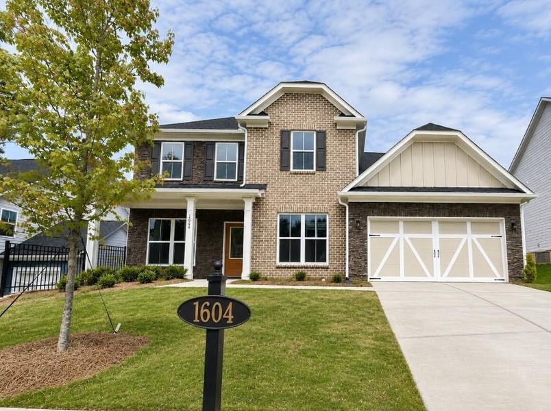 Front exterior of a new home in Berkeley Mill, Cumming, GA, highlighting curb appeal (Image 1). Front exterior of a new home in Berkeley Mill, Cumming, GA, highlighting curb appeal (Image 1).