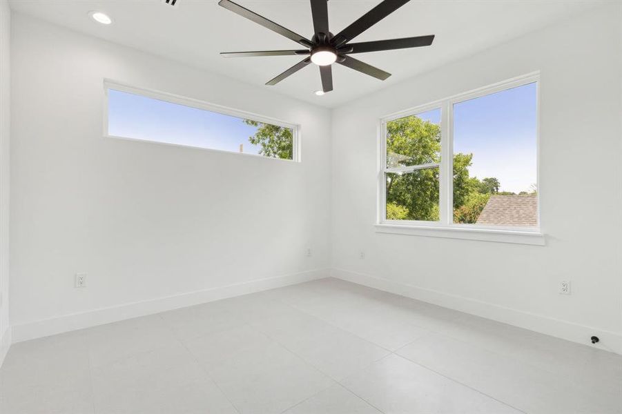 Unfurnished room featuring ceiling fan and light tile patterned floors