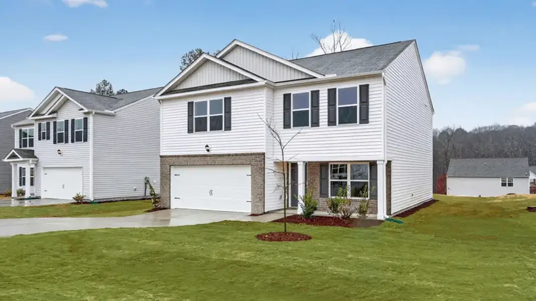 Front exterior of a new home in Mangum Farms, Stem, NC, highlighting curb appeal (Image 21). Front exterior of a new home in Mangum Farms, Stem, NC, highlighting curb appeal (Image 21).
