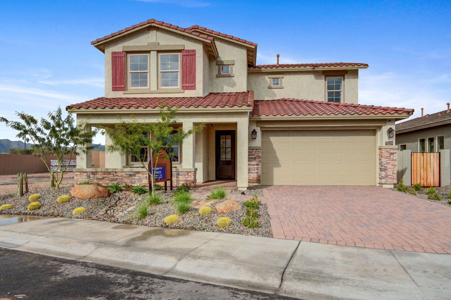 Front exterior of a new home in IronWing at Windrose, Litchfield Park, AZ, highlighting curb appeal (Image 1).