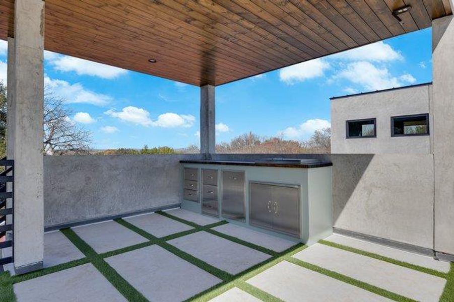 The covered 3rd floor outdoor kitchen area will easily hold the gang for entertaining or create a quiet respite day or night.