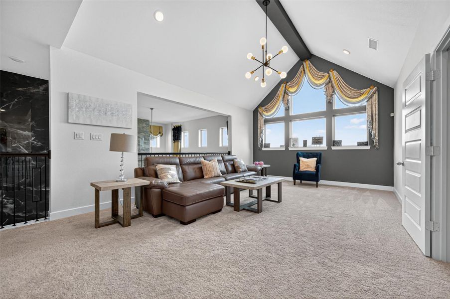 This spacious living area features a vaulted ceiling with modern lighting, large windows with decorative drapes, and plush carpet. It includes a cozy leather sectional, accent chair, and stylish decor, perfect for relaxation and entertainment. This spacious living area features a vaulted ceiling with modern lighting, large windows with decorative drapes, and plush carpet. It includes a cozy leather sectional, accent chair, and stylish decor, perfect for relaxation and entertainment.