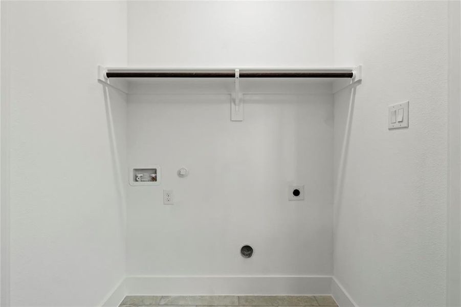 Laundry room featuring gas dryer hookup, electric dryer hookup, hookup for a washing machine, and light tile patterned flooring Laundry room featuring gas dryer hookup, electric dryer hookup, hookup for a washing machine, and light tile patterned flooring