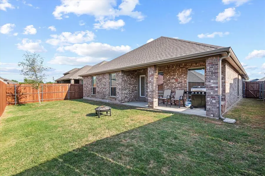 Rear of the home with a covered patio—an ideal space for grilling and enjoying time with family.