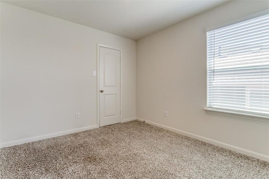 Carpeted spare room featuring plenty of natural light