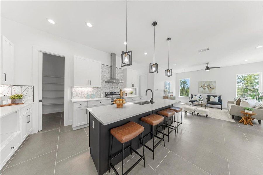 Kitchen featuring wall chimney exhaust hood, stainless steel range with electric stovetop, plenty of natural light, white cabinets, and recessed lighting Kitchen featuring wall chimney exhaust hood, stainless steel range with electric stovetop, plenty of natural light, white cabinets, and recessed lighting