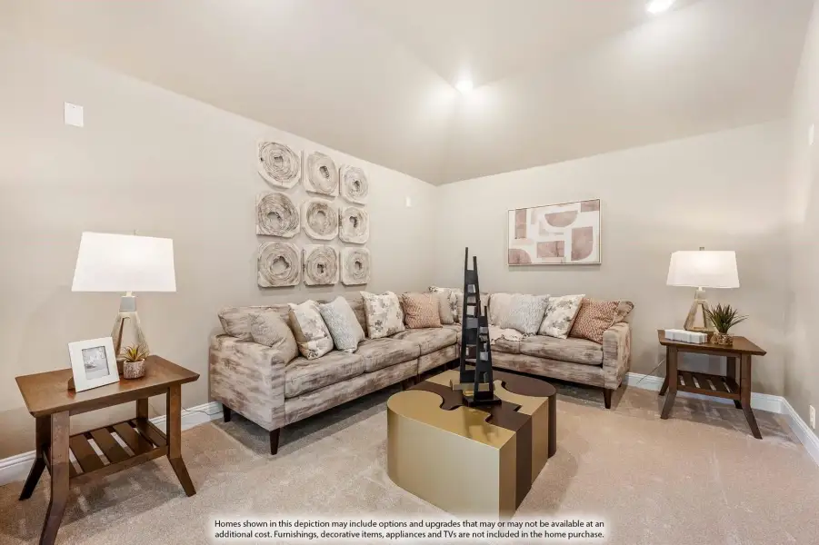 Living room with sectional sofa, vaulted ceiling, carpet flooring, and gold coffee table