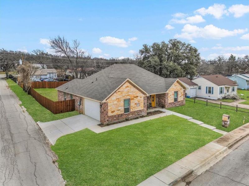 Single story home featuring a garage and a front yard