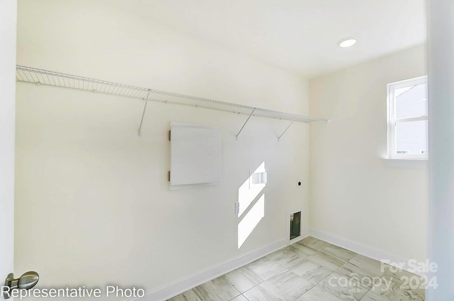 Laundry room will feature base cabinets with quartz counters