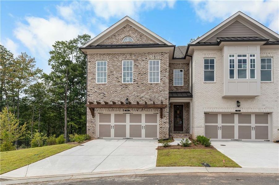 Front exterior of a new home in Ward's Crossing Townhomes, Johns Creek, GA, highlighting curb appeal (Image 27).