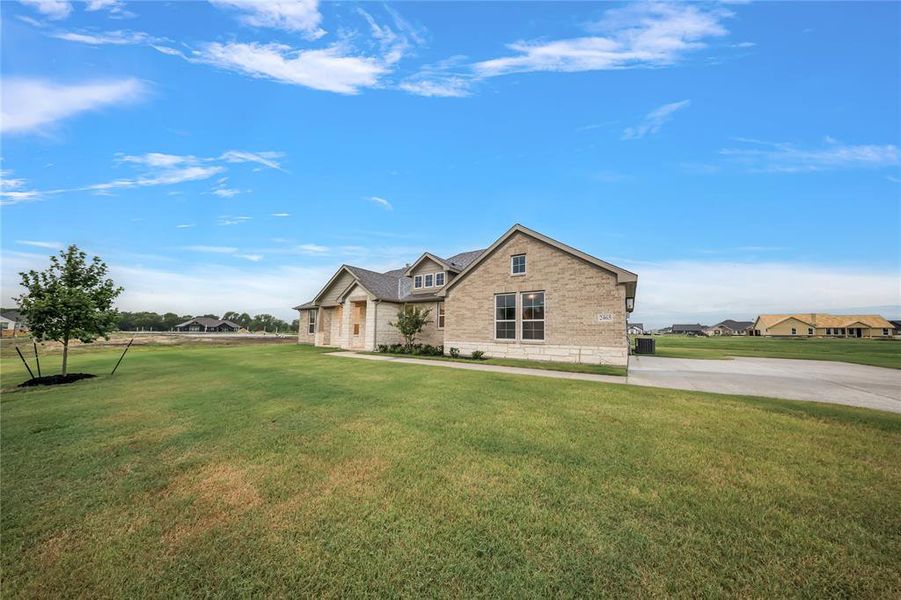 View of front of property with brick siding and a front yard View of front of property with brick siding and a front yard