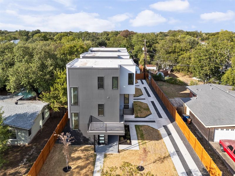 Clean lines and geometric architecture define this modern multi-level structure nestled among mature trees.