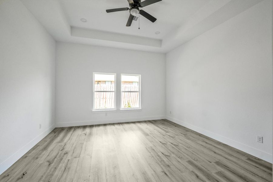 Master bedroom features an incandescent ceiling with recessed lighting giving it perfect blend of functionality and aesthetic