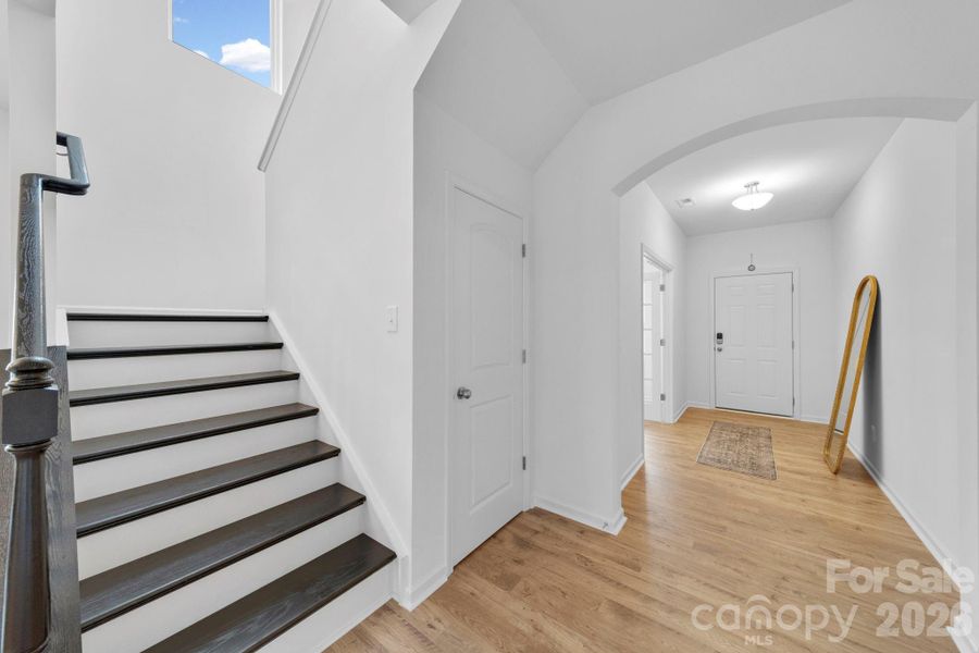 Wide Staircase with Hardwood/Composite Stair leading to Upper Level