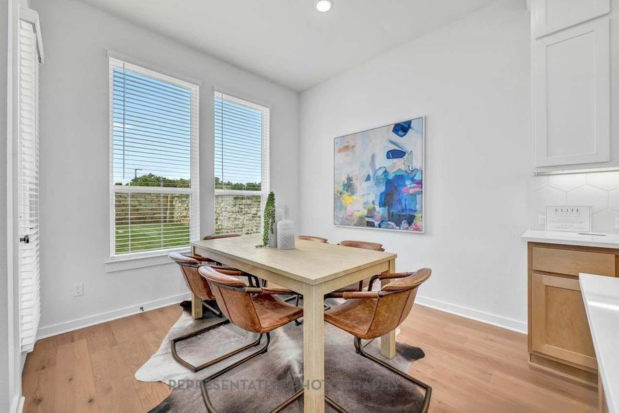 Dining space featuring light wood-style floors, recessed lighting, and a desk Dining space featuring light wood-style floors, recessed lighting, and a desk