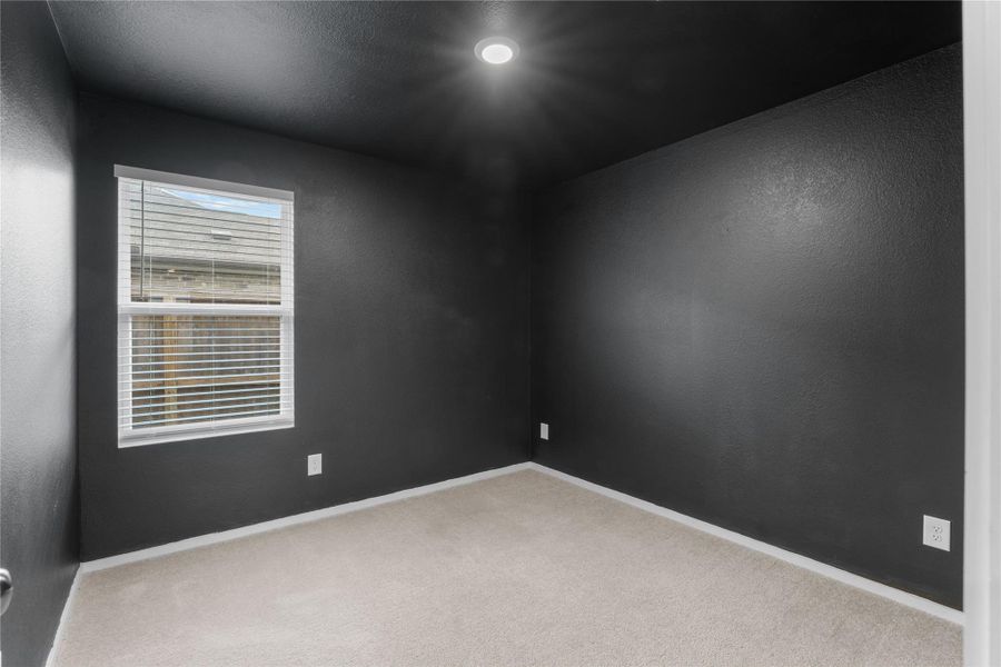 Bold black walls create a great setup for a media or game room.