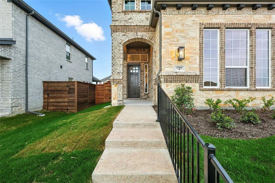 Entrance to property with brick siding and stone siding
