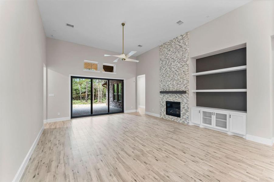 This fabulous living area features built-in shelves, high ceilings and a lovely fireplace