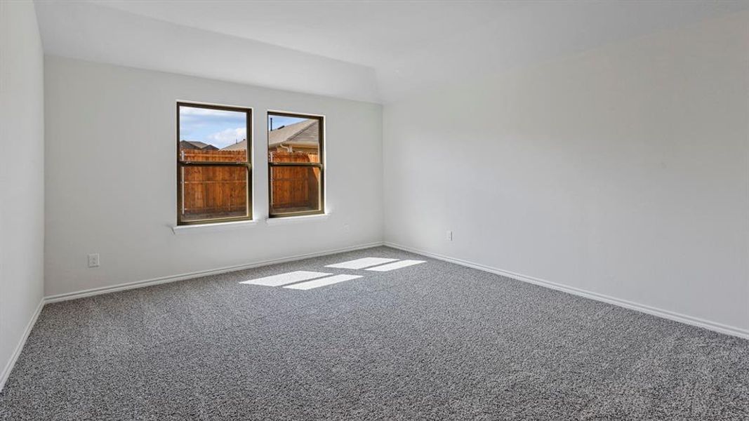 Spare room featuring carpet and vaulted ceiling Spare room featuring carpet and vaulted ceiling