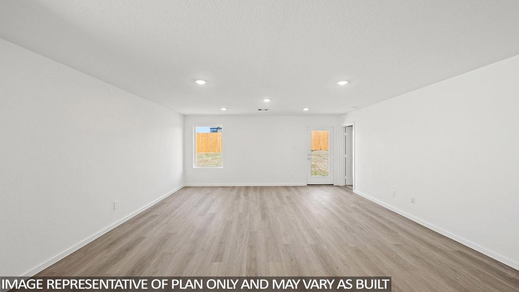 Empty room with light wood finished floors and recessed lighting