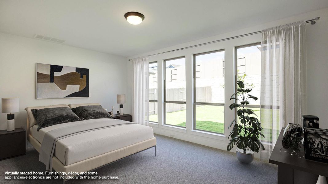 Carpeted bedroom featuring multiple windows Carpeted bedroom featuring multiple windows