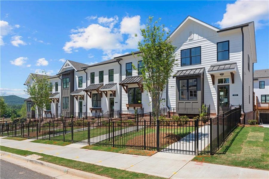 Front exterior of a new home in Palisades Townhomes, Cumming, GA, highlighting curb appeal (Image 2). Front exterior of a new home in Palisades Townhomes, Cumming, GA, highlighting curb appeal (Image 2).