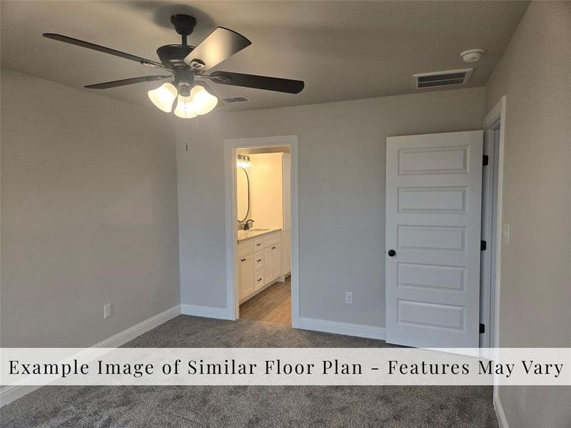 Unfurnished bedroom with dark colored carpet, ceiling fan, and connected bathroom