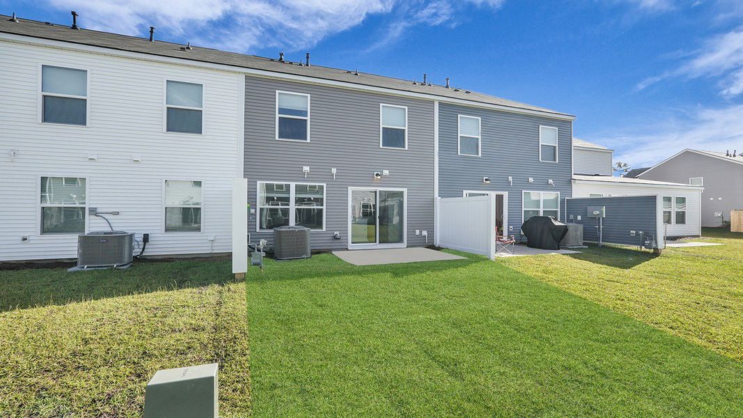 Exterior details and patio area of a home in Pine Hills Townhomes at Cane Bay, Summerville (Image 22).