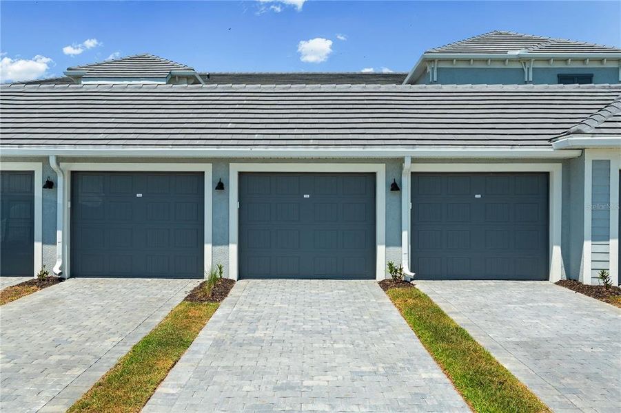 Front exterior of a new home in Calusa Country Club, Lakewood Ranch, FL, highlighting curb appeal (Image 29).