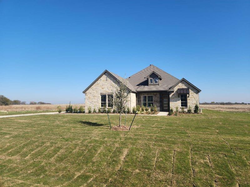 Front exterior of a new home in Rocky Top, Krum, TX, highlighting curb appeal (Image 2). Front exterior of a new home in Rocky Top, Krum, TX, highlighting curb appeal (Image 2).