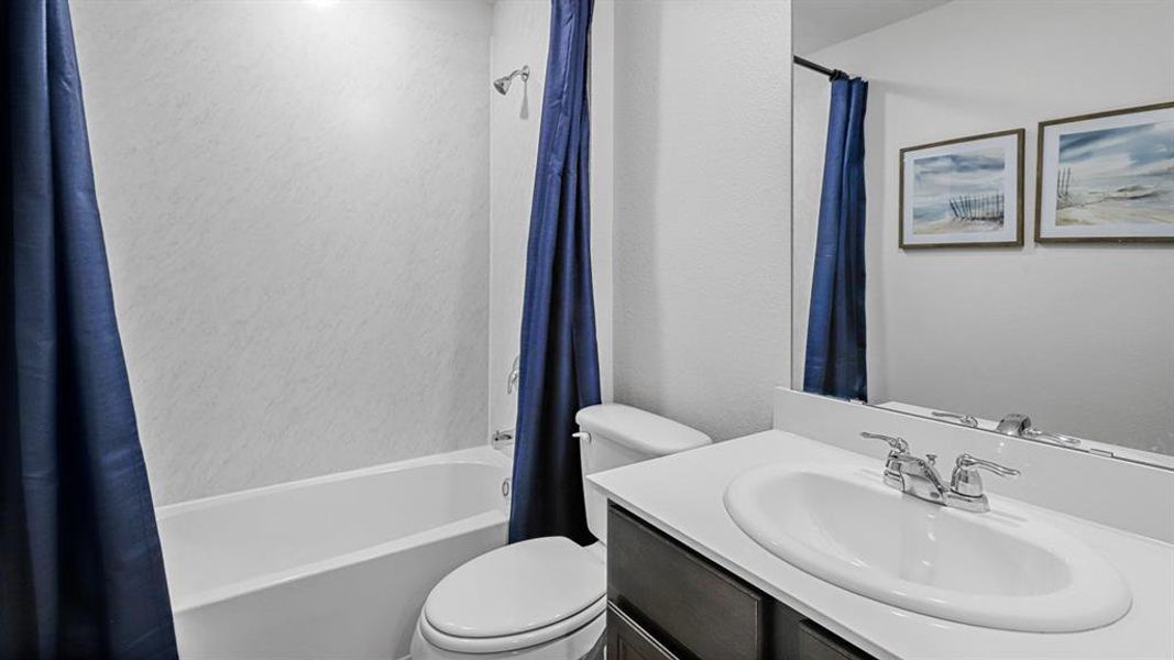Bathroom featuring vanity and shower / bath combo with shower curtain Bathroom featuring vanity and shower / bath combo with shower curtain