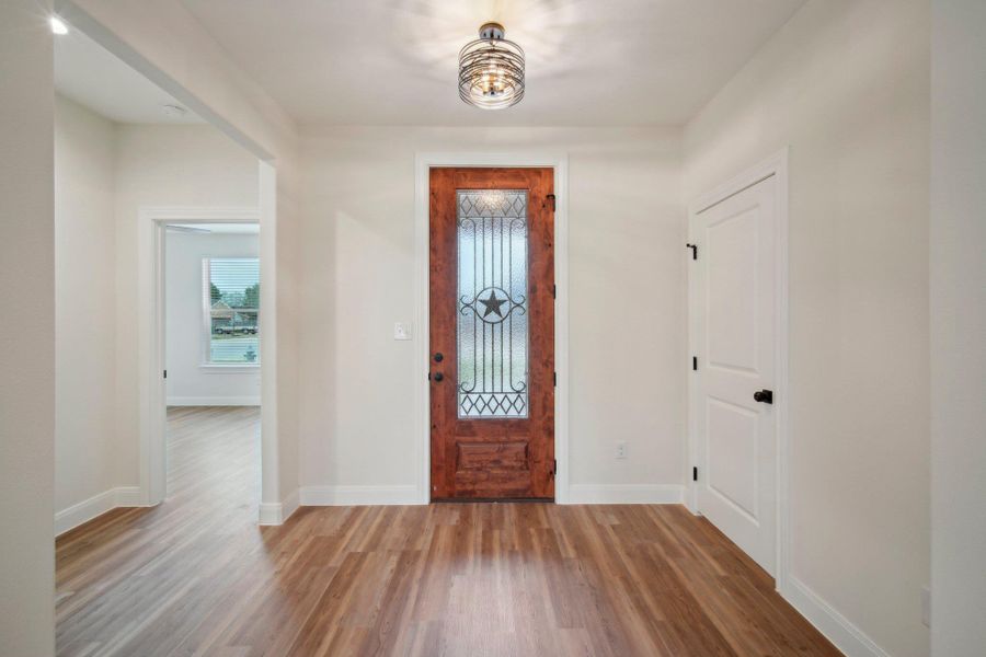 Entrance foyer featuring wood finished floors and baseboards