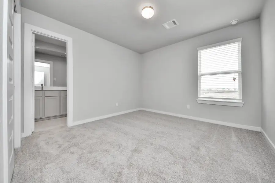 Generously sized secondary bedrooms featuring spacious closets, soft and inviting carpeting underfoot, large windows allowing plenty of natural light, and the added touch of privacy blinds for your personal retreat. Sample photo of completed home with similar floor plan. Actual colors and selections may vary.
