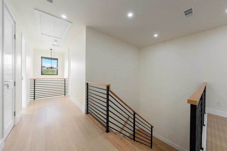 Hall featuring attic access, recessed lighting, an upstairs landing, and light wood-type flooring