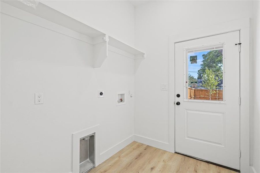 Laundry area with light wood-style floors, electric dryer hookup, and hookup for a washing machine Laundry area with light wood-style floors, electric dryer hookup, and hookup for a washing machine