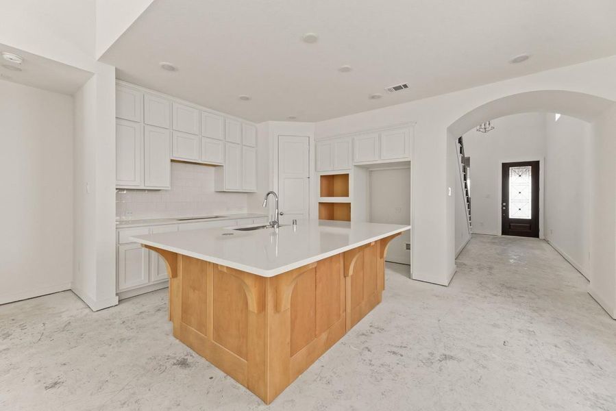 Featuring two-tone cabinetry, sleek quartz countertops, and an extra row of upper cabinets, this kitchen is both stylish and functional. Built-in stainless steel appliances will be installed to complete the space. Featuring two-tone cabinetry, sleek quartz countertops, and an extra row of upper cabinets, this kitchen is both stylish and functional. Built-in stainless steel appliances will be installed to complete the space.