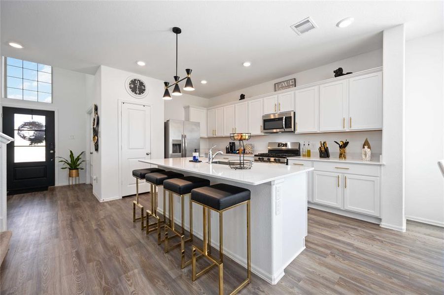 Gourmet kitchen with upgraded white cabinetry and gold hardware