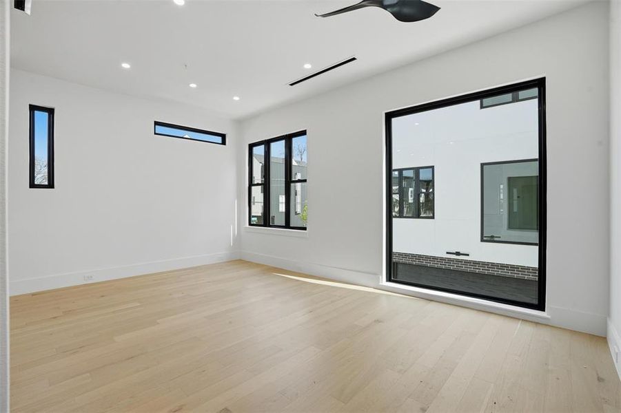 The open-concept floor plans are flooded with natural light from oversized Andersen windows, shown here