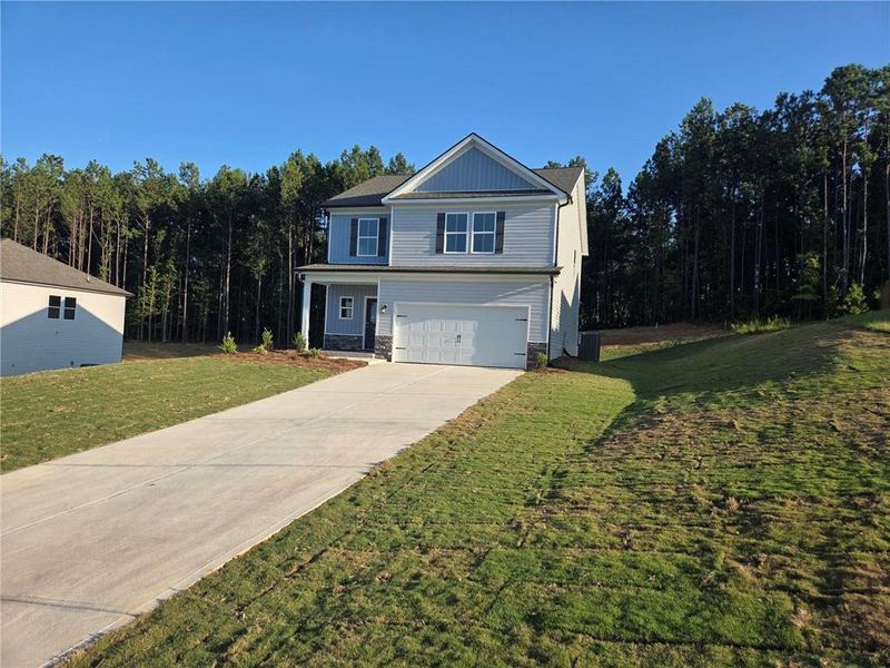 Front exterior of a new home in Savoy Park, Covington, GA, highlighting curb appeal (Image 1). Front exterior of a new home in Savoy Park, Covington, GA, highlighting curb appeal (Image 1).