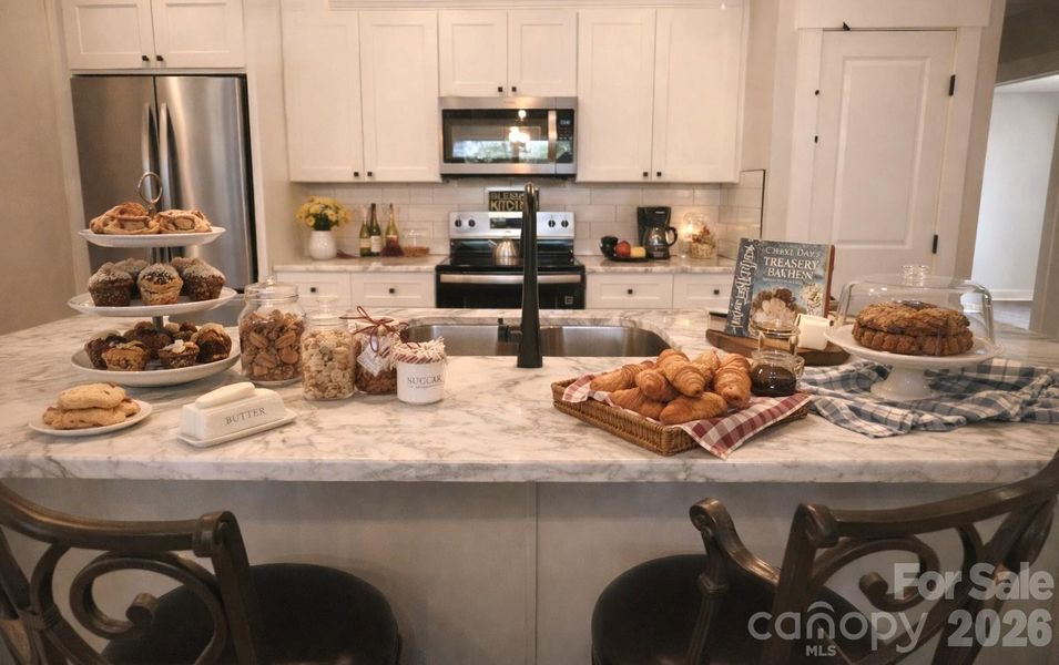Dream Kitchen with large island for prep and breakfast & two Pantries for storage. Big bonus for this home.