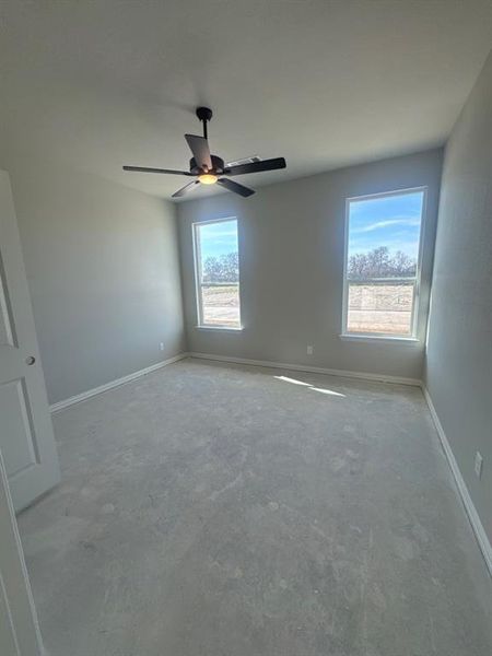 Spare room with baseboards and ceiling fan