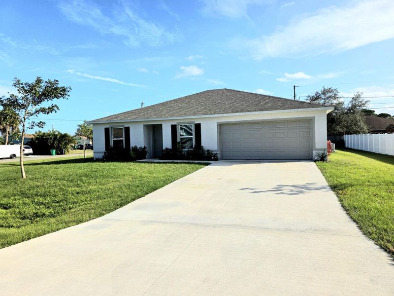Front exterior of a new home in , Port St. Lucie, FL, highlighting curb appeal (Image 9).