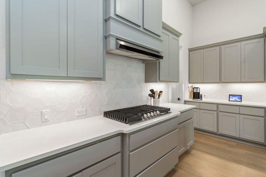 Culinary delights await in this modern kitchen with ample counter space and sophisticated cabinetry.