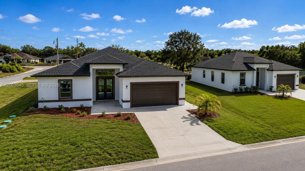 Front exterior of a new home in , Lehigh Acres, FL, highlighting curb appeal (Image 22).